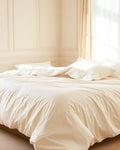 Sateen Duvet Cover in Ivory on bed